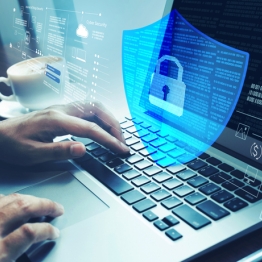 Person typing on a laptop with a transparent digital shield and lock icon overlay, representing cybersecurity, data protection, and secure online access.