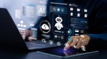 Business professional using laptop and tablet with holographic AI interface showing AI agents, cloud, and cybersecurity tools for global digital defense.