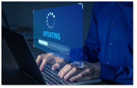 hands on a laptop with a floating 'updating' progress bar screen in front of the screen