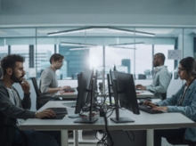 Workers at monitors in an open office