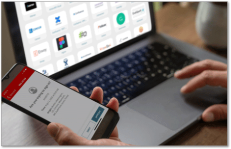 Laptop showing AuthPoint web portal on a laptop and authentication screen on a phone